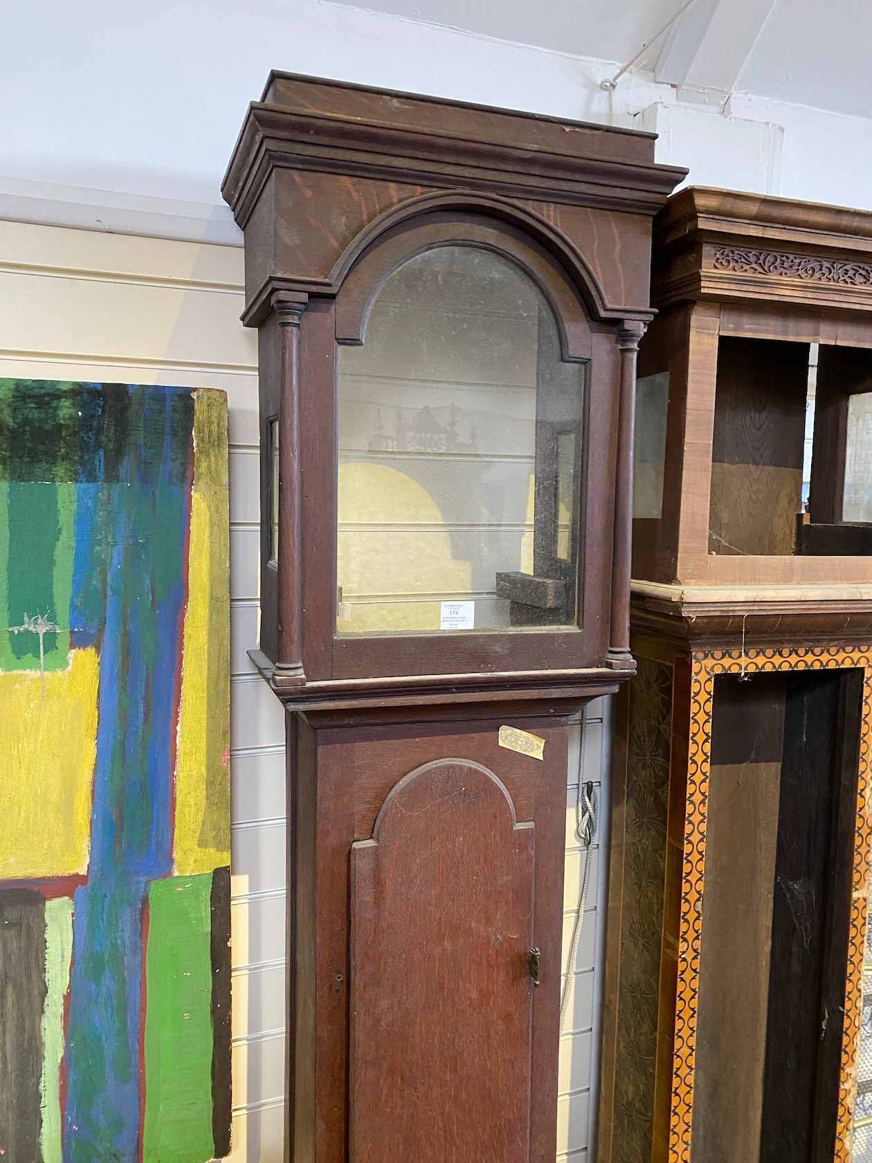 A George III oak longcase clock case and an inlaid clock case, larger 222 cm high.